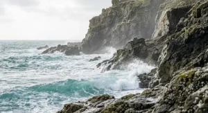 Atmospheric shot of crashing turquoise waves in Cornwall, capturing the essence of a fresh marine fragrance for women.
