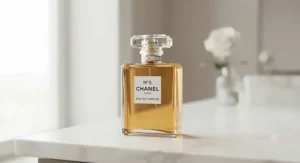 A classic bottle of Chanel No. 5, the signature Chanel perfume for women, displayed on a minimalist marble surface.