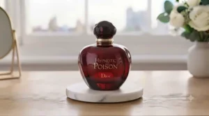 Deep red, iconic apple-shaped bottle of Dior Hypnotic Poison fragrance.