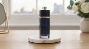 Iconic gold-neck bottle of J'adore Eau de Parfum reflecting soft ambient light.