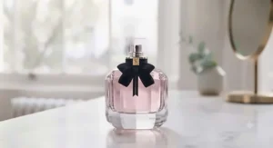 A clear view of the YSL Mon Paris bottle featuring its distinctive black bow, displayed in a sophisticated dressing area.